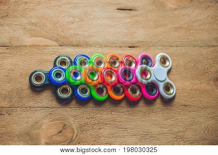 Colored Fidget Spinners Stress Relieving Toy On Wooden Background
