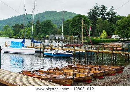 Boats in Bowness on Windermere, view of the lake and mountain on the back, Cumbria, selective focus