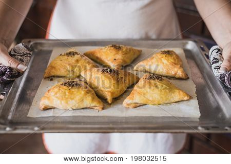 Uzbek National Cuisine. Samsa On A Tray, In Female Hands. Horizontal Frame