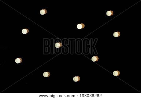 Blur white heptagon bokeh on black background