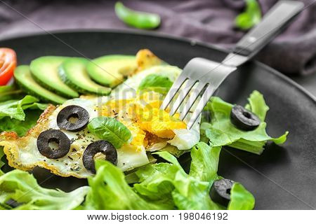 Plate with over hard fried egg and vegetables, closeup