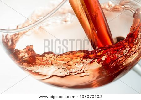 Wine splashing on glass isolated on white background