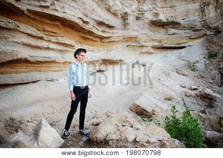 An Attractive Man Is Standing In The Middle Of A Sand Quarry And Looking Thoughtfully In The Distanc