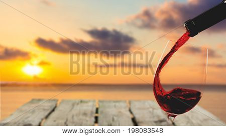 Red glass pouring wine color background party