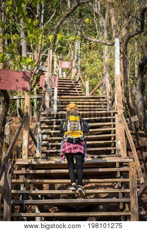 Tourist Young Woman Wearing Hat Enjoying The Walk Up The Stairs On The Mountain.