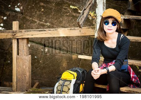 Tourist Young Woman Wearing Hat Enjoying Sitting On The Stairs Mountain.