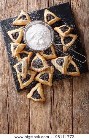 Hamentashen Triangular Cookies With Poppy Seed For Purim Holiday Close-up. Vertical Top View