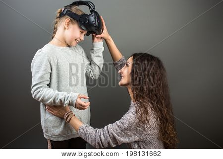 Mother And Child Playing Together With Virtual Reality Headsets