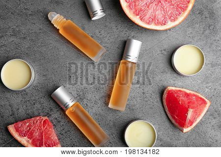 Bottles of perfume, jars and grapefruit on table