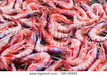 Fresh shrimps Gambos on grill close-up outdoors