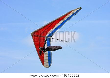 Hang Glider flying in a blue sky
