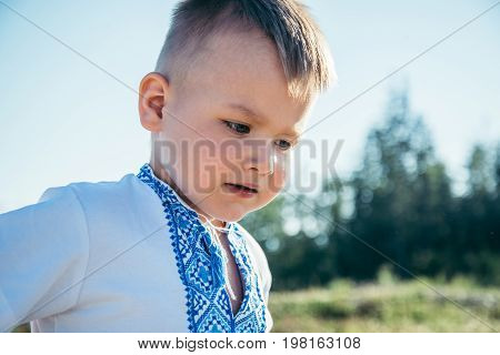 little boy playing on the top of the mountain with beautifull view on background