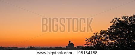 Christian church in the east sun. Church on the horizon.