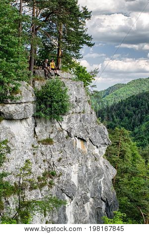 TOMASOVSKY VYHLAD SLOVAKIA - JUN 3: Tourists sitting on the rock at viewpoint in Slovak paradise on Jun 3 2017 in Tomasovsky vyhlad
