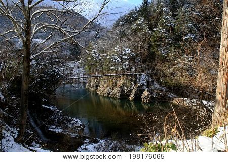 A conduit crosses a river in Shirakawago
