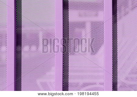 Purple Background Sheet Of Metal Covered With Lines Of Circular Holes