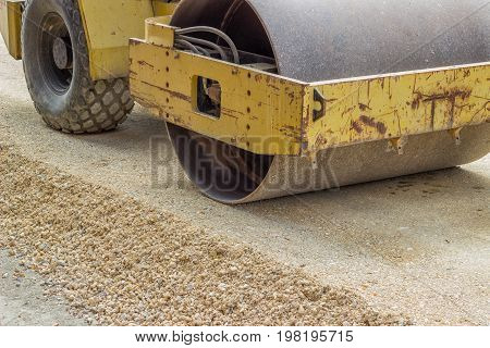 Yellow Vibratory Steel Drum Compactor During Road Construction