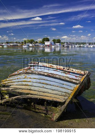 Derelict boats in the backwaters of Holes Bay Poole Harbour at low tide