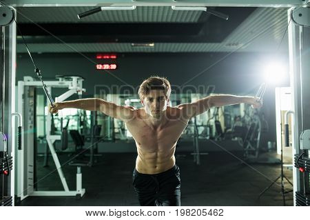 Muscular Man Lifting Weights In Fitness Gym Center