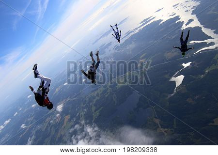 Skydiving over beautiful Norway. Clouds, sun and sky