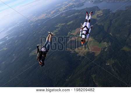 Skydiving over beautiful Norway. Clouds, sun and sky
