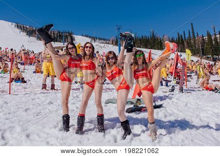 Group Of Young Happy Pretty Women On A Snowboard In Colorful Bikini.