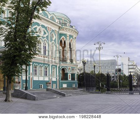 YEKATERINBURG, RUSSIA - 22 JULY, 2017: Quay city pond, Sevastyanov's house at sunset time