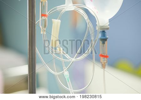 Close up saline IV drip for patient and Infusion pump in hospital.