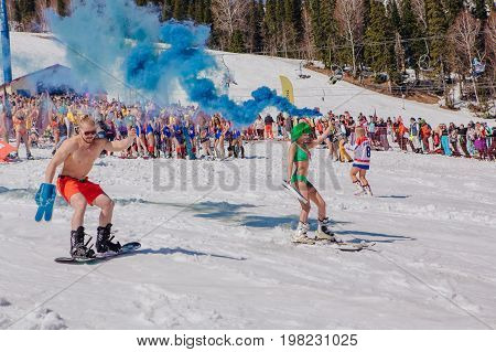Group Of Young Happy Pretty Women On A Snowboard In Colorful Bikini With Flags.