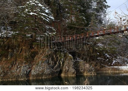 A conduit crosses the river in Shirakawa-go