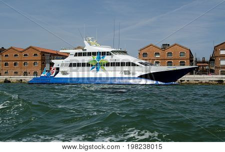 VENICE ITALY - JUNE 10 2017: View of the catamaran ferry Prince of Venice moored along the Giudecca Canal in Venice Italy on a sunny afternoon. Part of the Adriatic Lines group of ferries it transports passengers across the Adriatic Sea between Venice and