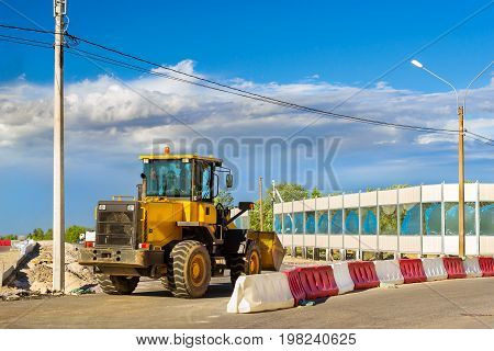 Bulldozer with bucket on construction of high-speed bypass road around Krasnoe Selo Saint Petersburg. Heavy machine equipment for excavation works at civil industrial construction. Russia