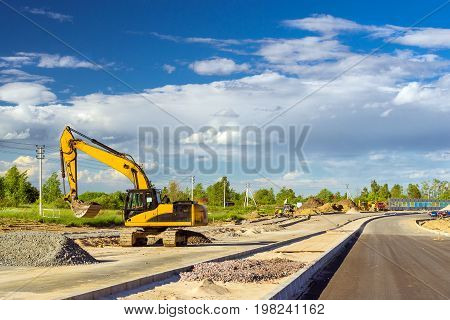 Crawler Excavator digging bucket on construction of high-speed bypass road around Krasnoe Selo Saint Petersburg. Heavy machine equipment for excavation works at civil industrial construction. Russia