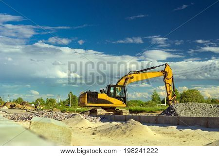 Crawler Excavator digging bucket on construction of high-speed bypass road around Krasnoe Selo Saint Petersburg. Heavy machine equipment for excavation works at civil industrial construction. Russia