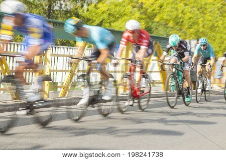 Group of cyclist during a race on a bridge motion blur