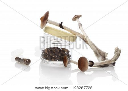 Dried and fresh Magic mushrooms in glass jar isolated on white background