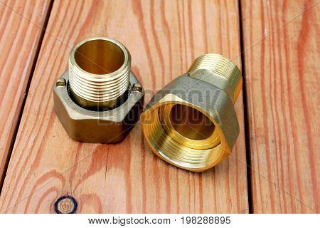 Two bronze mufts on a wooden table