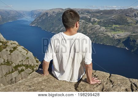 Norwegian fjord landscape. Hiker. Preikestolen landmark. Norway adventure tourism