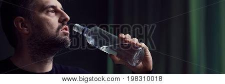 Man Drinking Alcohol From Bottle