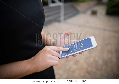 Roaming free zone text on European Union flag against businesswoman using mobile phone