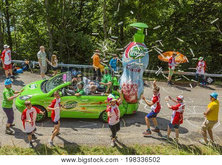 Mont du Chat France - July 9 2017: Excited fans trying to catch the gifts thrown from a Teisseire vehicle during the passing of Publicity Caravan on Mont du Chat during the stage 9 of Tour de France 2017.