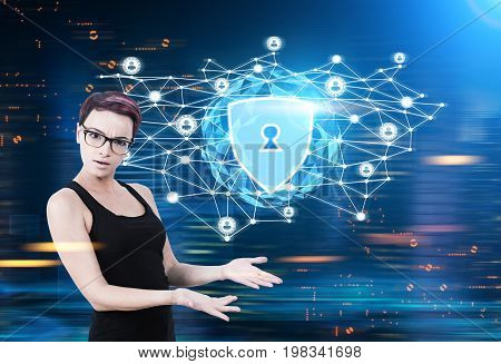 Close up of a surprised nerd woman with purple hair wearing glasses and a black tank top. She is standing against a glowing security shield hologram. Blue. Toned image mock up double exposure