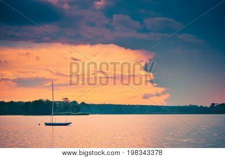 Boat on the water. Evening landscape by the lake.