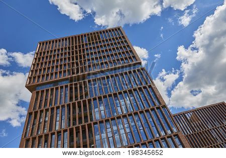 Veiw on new loft style modern building made of brown bricks with big wide windows EGODOM. Rectangular building architecture. Russian modern loft architecture. Luxury real estate