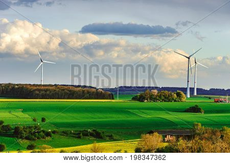 Beautiful Landscape With Yellow And Green Fields And Windfarm On Horizon Line