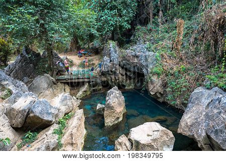 VANG VIENG LAOS - MARCH 14 2017: The beautiful Blue Lagoon with tropical vegetation at Tham Chang Cave close to the city of Vang Vieng Laos.