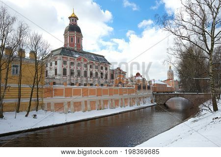 A cloudy April day on the Monastyrka river. View of the Annunciation Church of the Alexander Nevsky Lavra. St. Petersburg, Russia