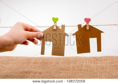 Hand holding a aper house on a canvas background