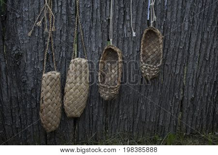 The old bast shoes hang on the fence and dryed