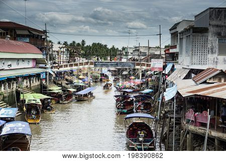 SAMUT SONGKHRAM, THAILAND - JULY 22, 2017 : AMPHAWA FLOATING MARKET is one of the most exciting and colorful places to visit in Thailand today.